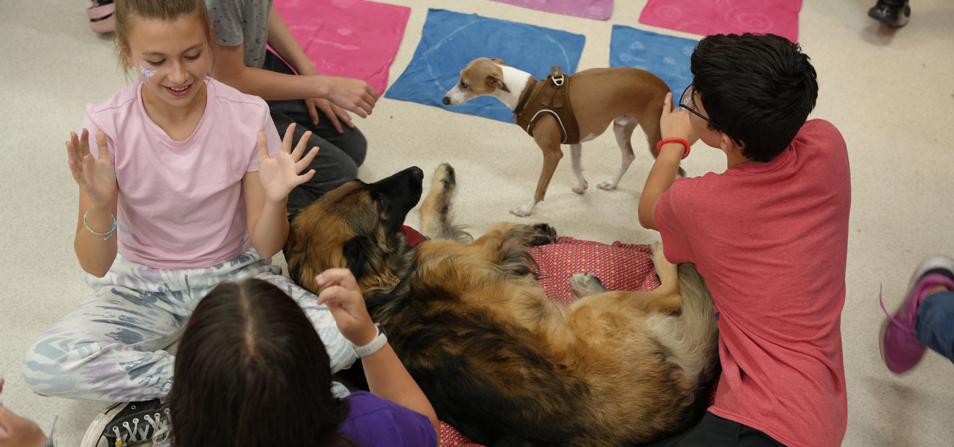 Kids at after school club having fun and hanging out with a dog