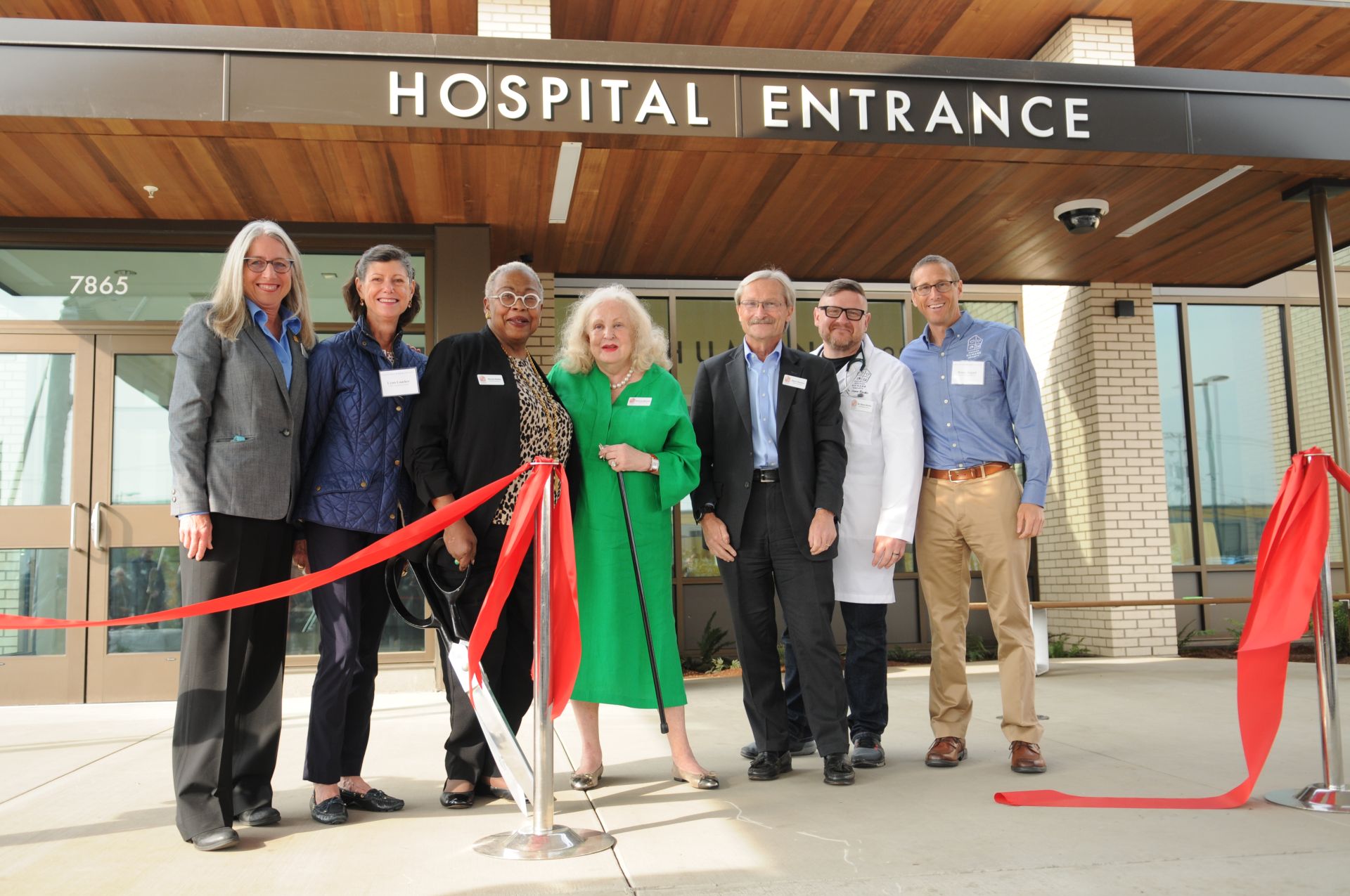 OHS opens new Community Veterinary Hospital. Photo shows executive staff and board members posing at the ribbon cutting ceremony.